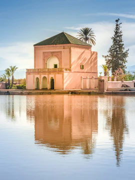 Menara Pavilion reflecting in a tranquil pond, Marrakech, Morocco.