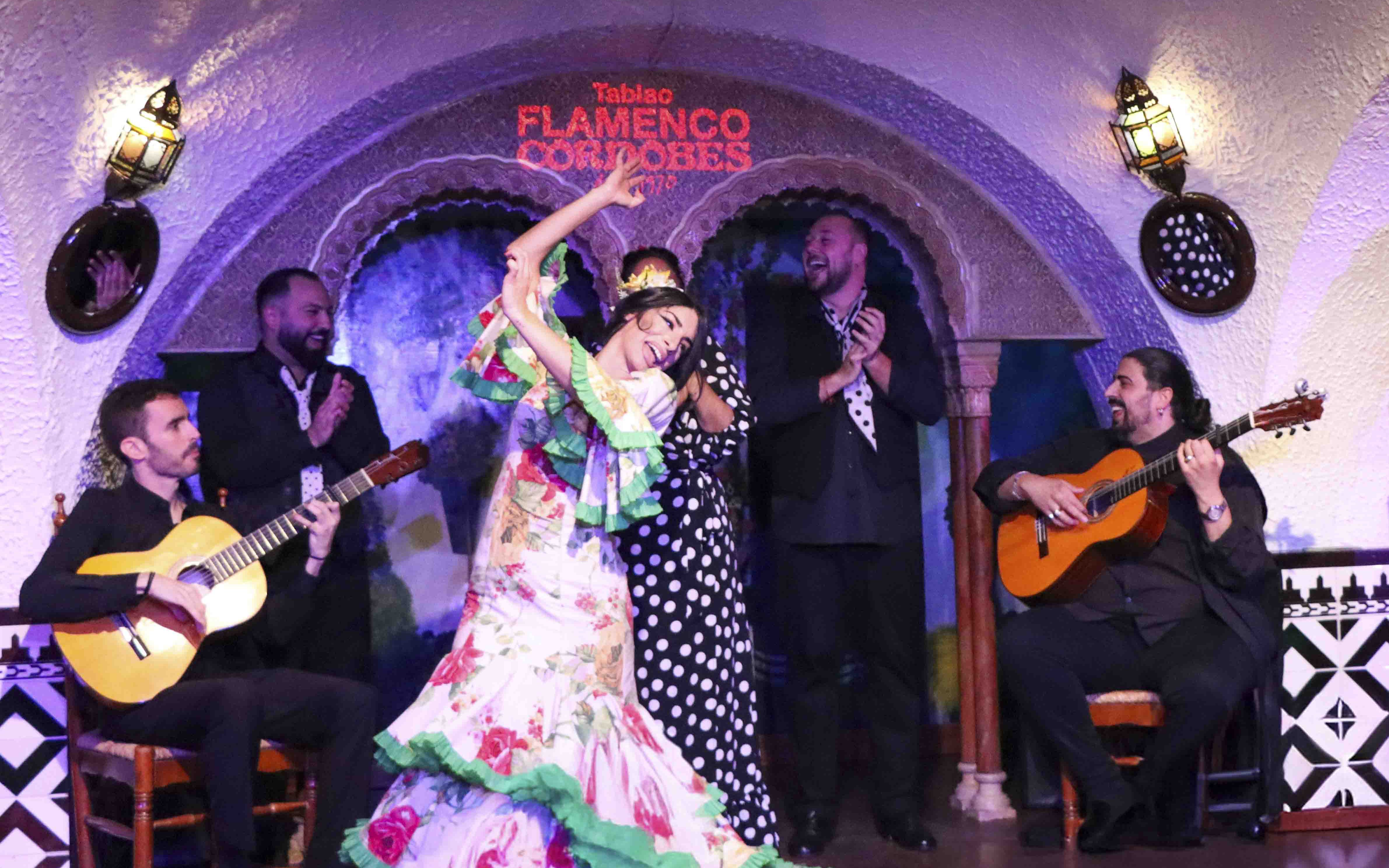 Flamenco dancers performing at Tablao Cordobes with guitarists.