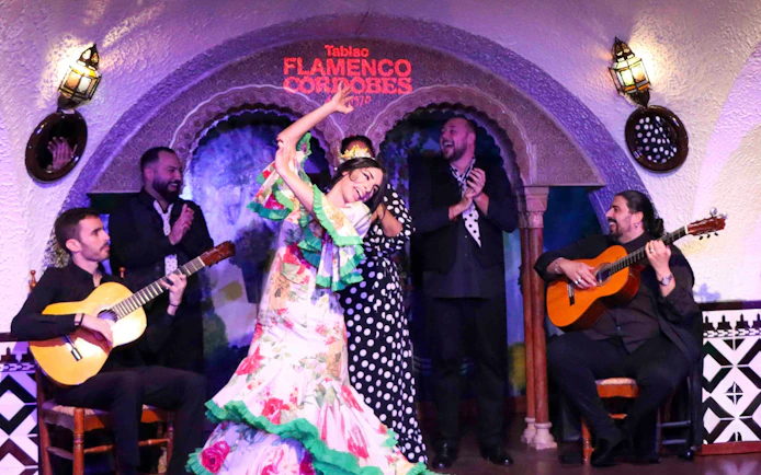 Flamenco dancers performing at Tablao Cordobes with guitarists.