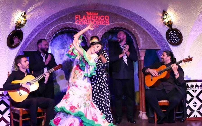 Flamenco dancers performing at Tablao Cordobes with guitarists.