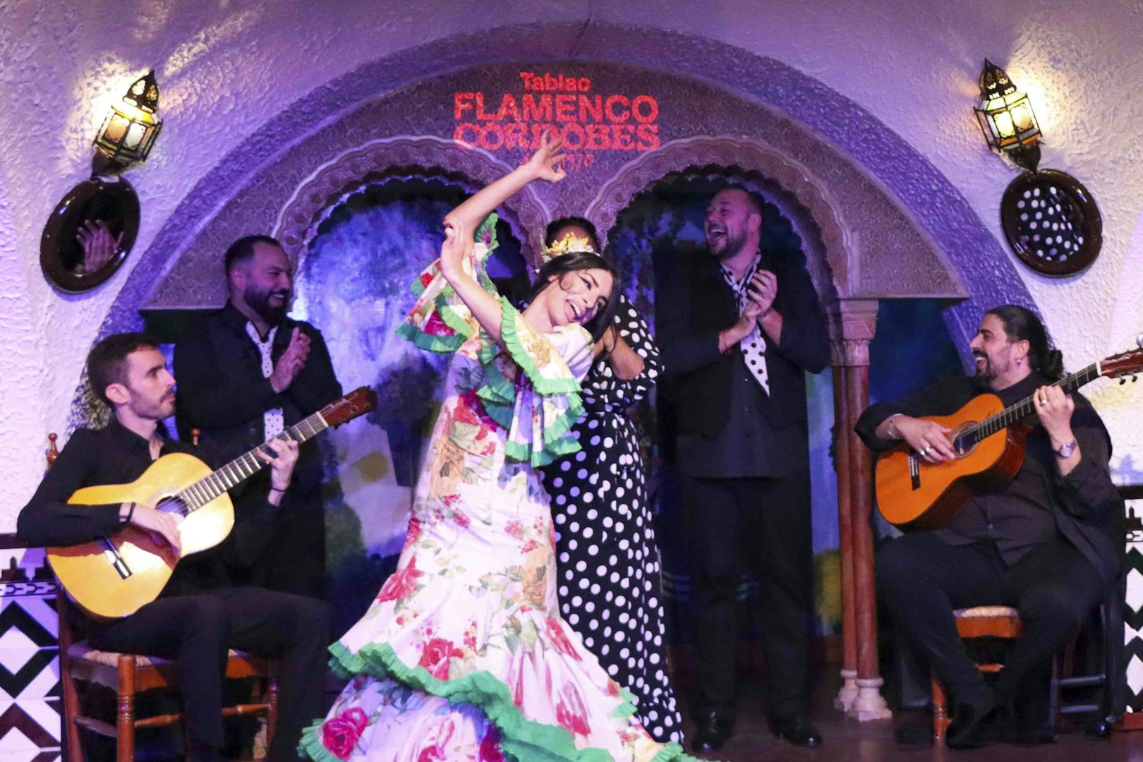 Flamenco dancers performing at Tablao Cordobes with guitarists.