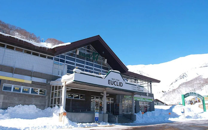Hakuba47 Ski Resort Base Lodge Euclid with snowy mountain backdrop, Nagano.