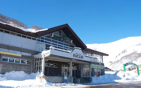 Hakuba47 Ski Resort Base Lodge Euclid with snowy mountain backdrop, Nagano.