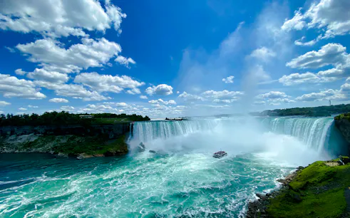 Niagara Falls with tour boat on water, view from Toronto day tour.