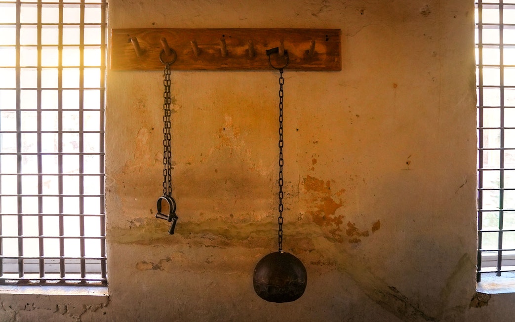 Chains and shackles on a wall at the Medieval Torture Museum exhibit.