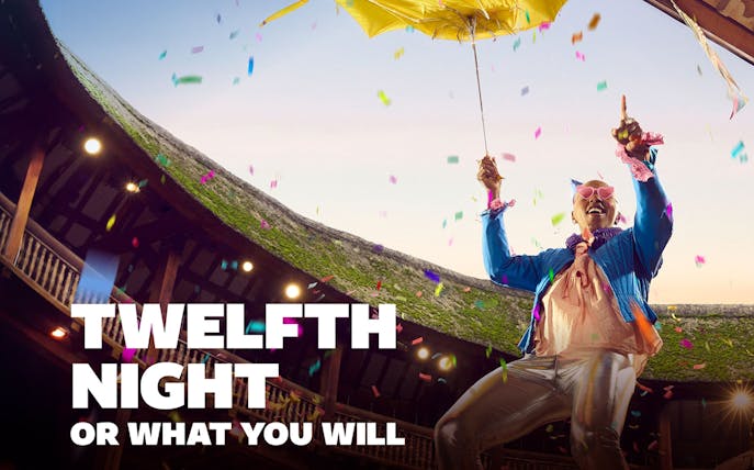 Performer celebrating with confetti at Twelfth Night event in an open-air theater.