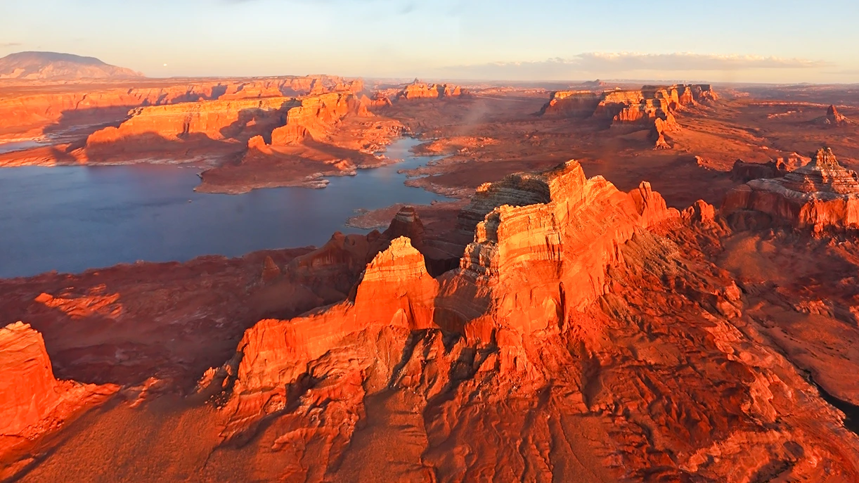 Aerial view of Antelope Canyon's red rock formations and winding river in Arizona.