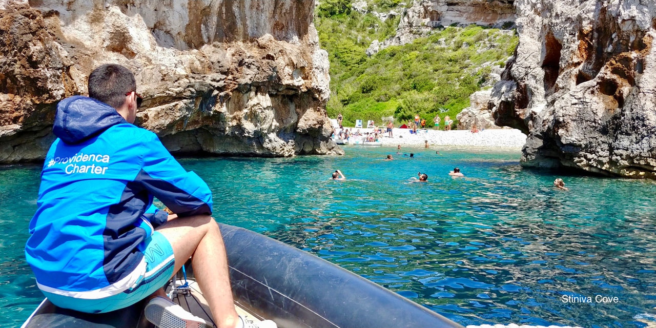 Stiniva Cave entrance with a boat tour exploring Blue Cave, Blue Lagoon, and nearby islands.