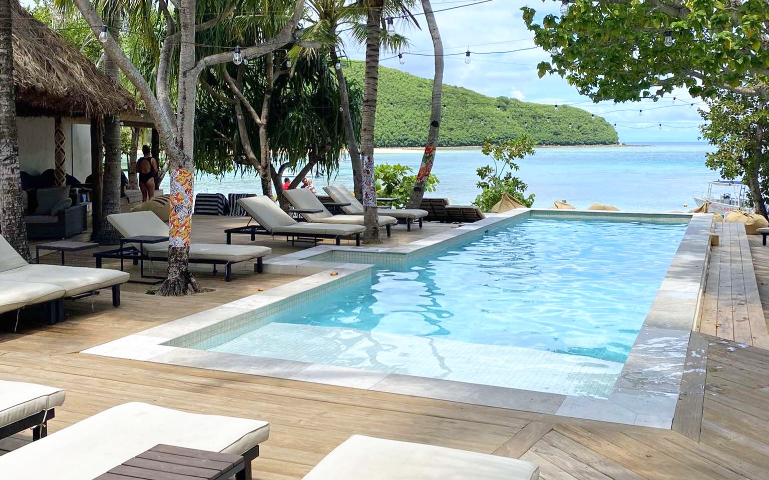 Poolside view at Mantaray Island Resort, Fiji with loungers and ocean backdrop.