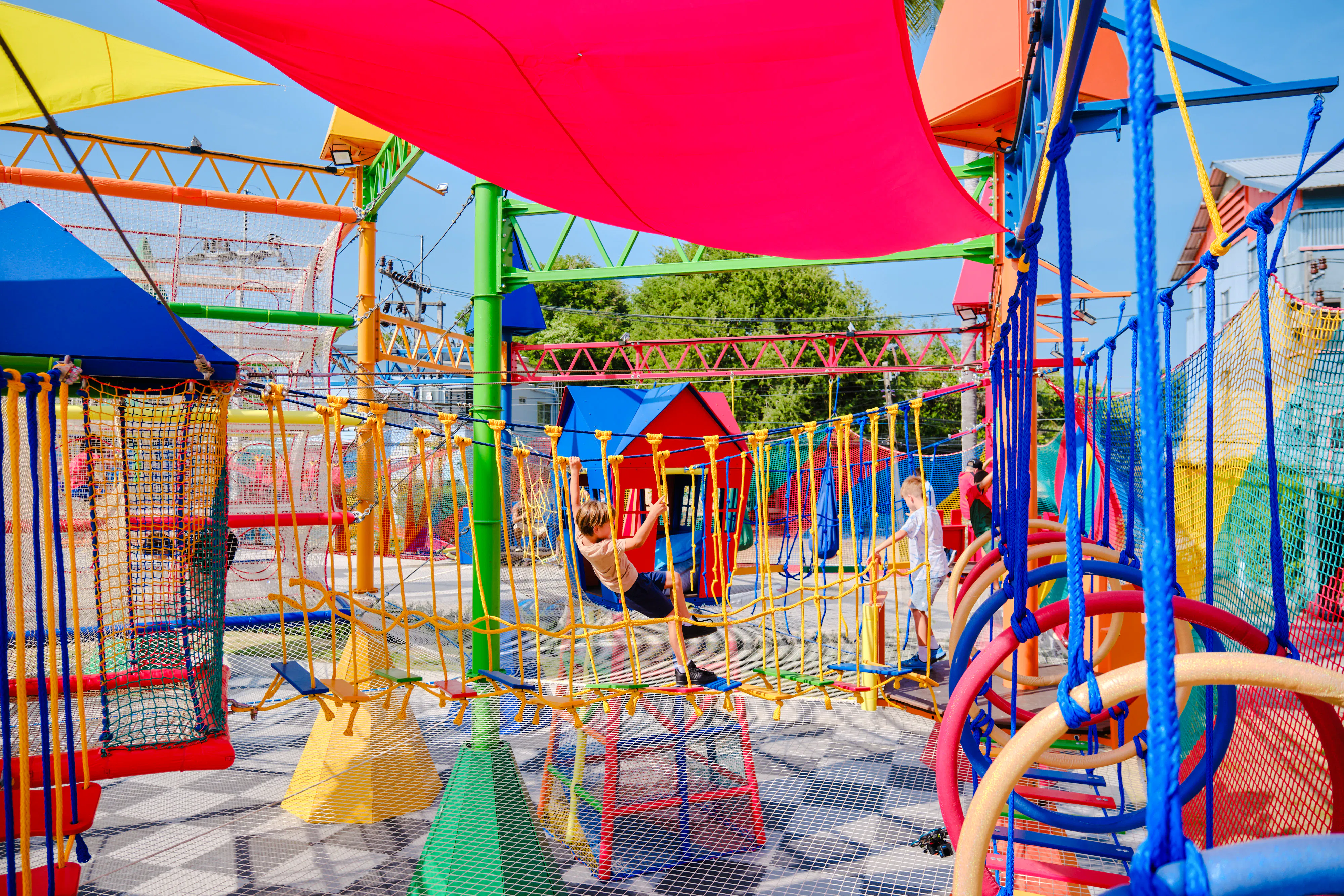 Children playing on colorful playground equipment during a birthday party in Phuket.