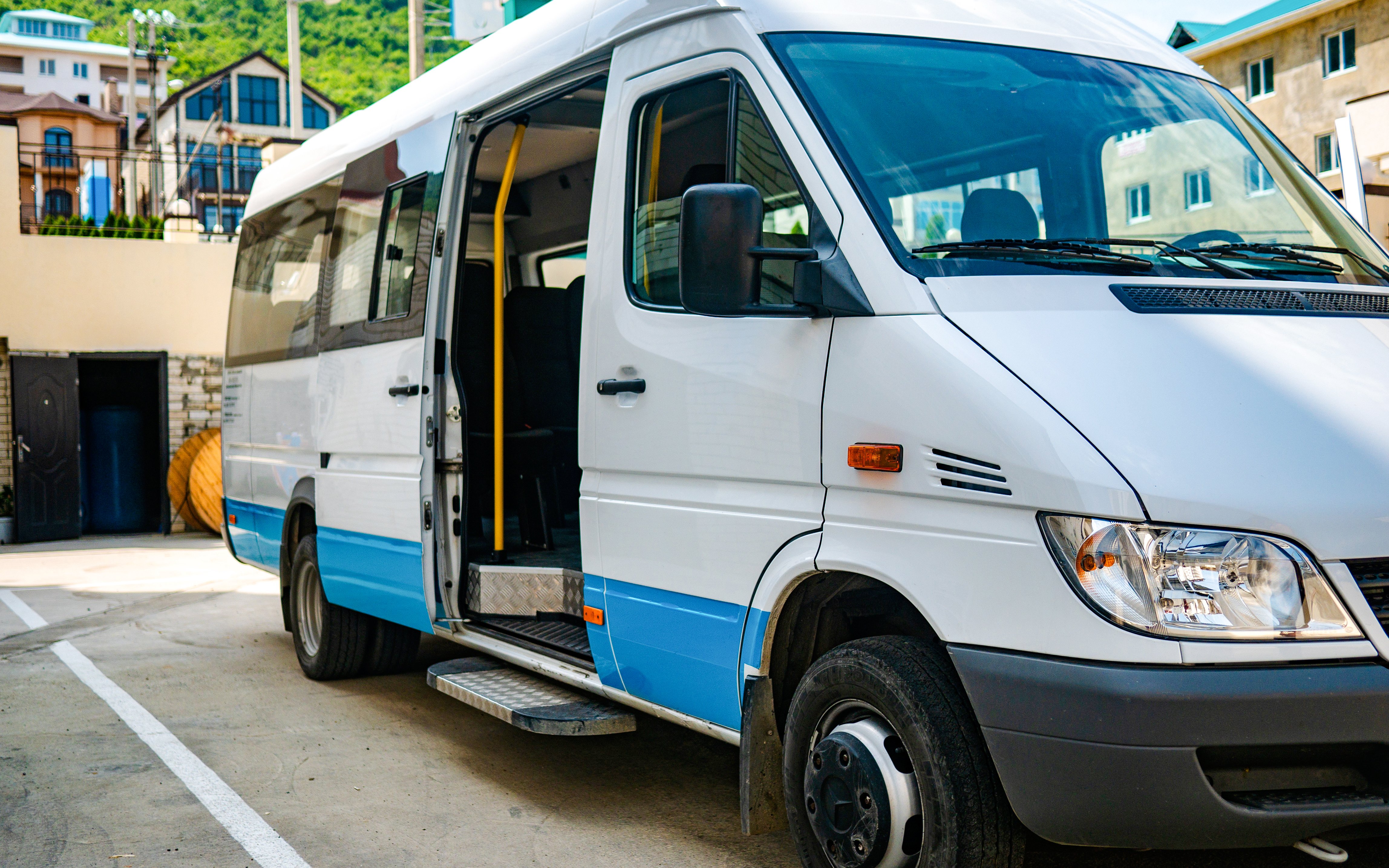 Shuttle bus parked in Ireland with open door for tours.
