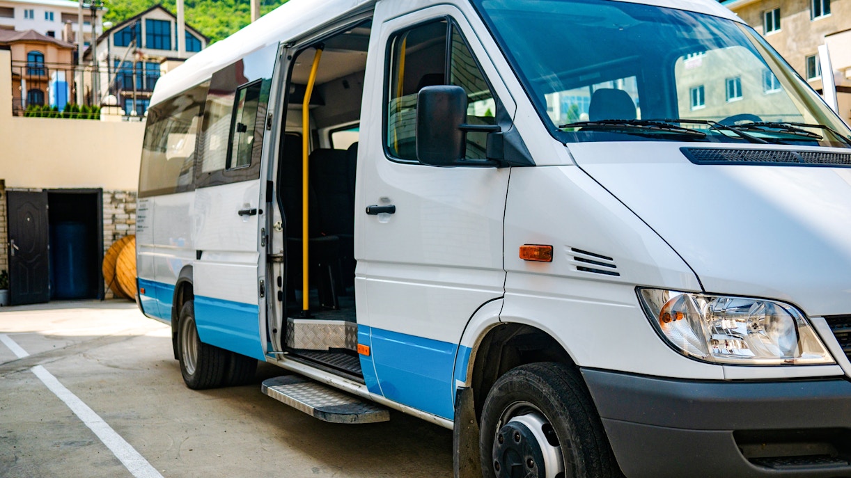 Shuttle bus parked in Ireland with open door for tours.