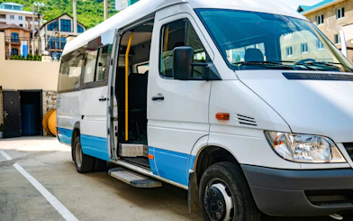 Shuttle bus parked in Ireland with open door for tours.