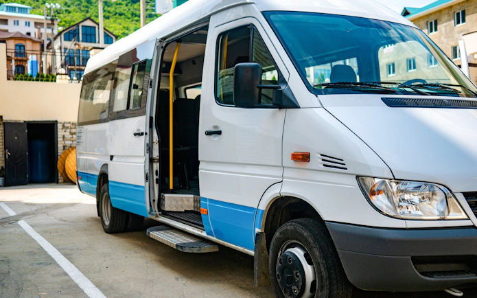 Shuttle bus parked in Ireland with open door for tours.