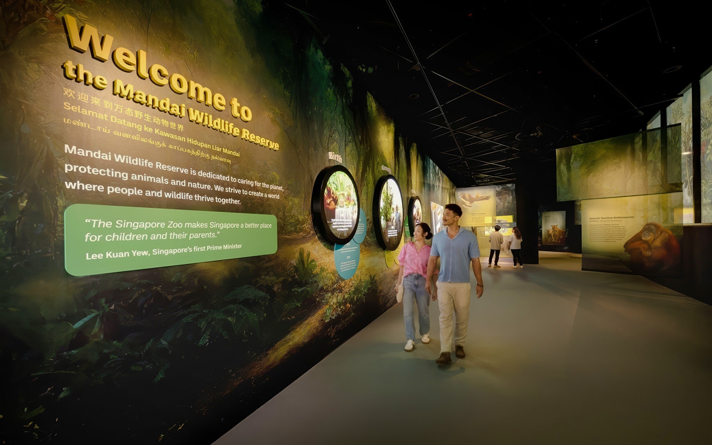 Tourists walking through Mandai Wildlife Reserve entrance exhibit in Singapore.