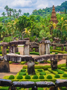 Nong Nooch Tropical Garden in Pattaya with stone structures and lush greenery.