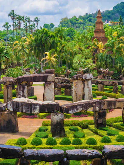 Nong Nooch Tropical Garden in Pattaya with stone structures and lush greenery.