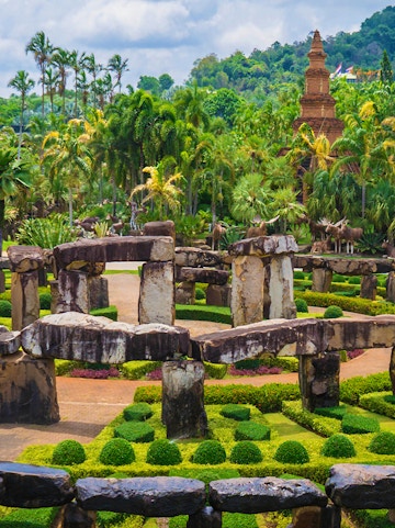 Nong Nooch Tropical Garden in Pattaya with stone structures and lush greenery.