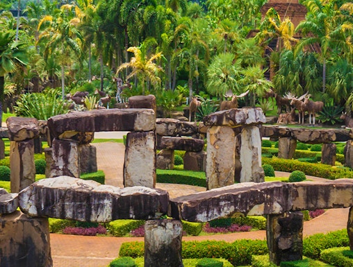 Nong Nooch Tropical Garden in Pattaya with stone structures and lush greenery.
