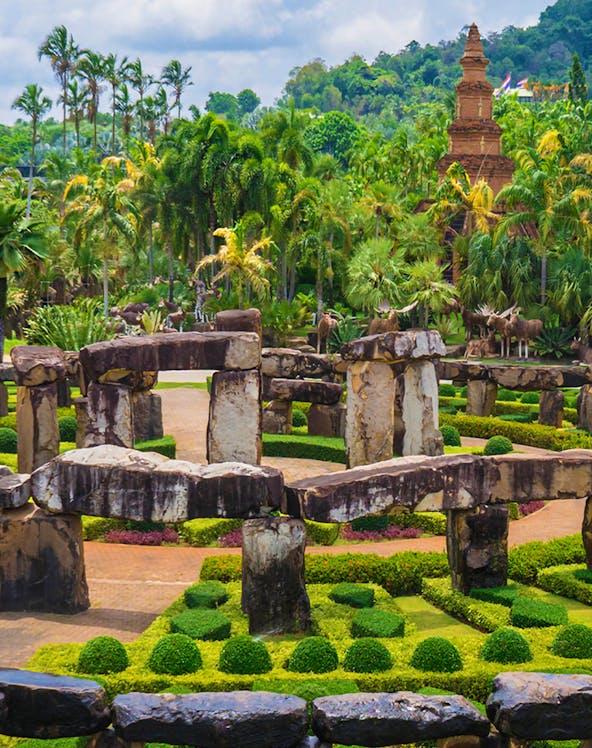 Nong Nooch Tropical Garden in Pattaya with stone structures and lush greenery.
