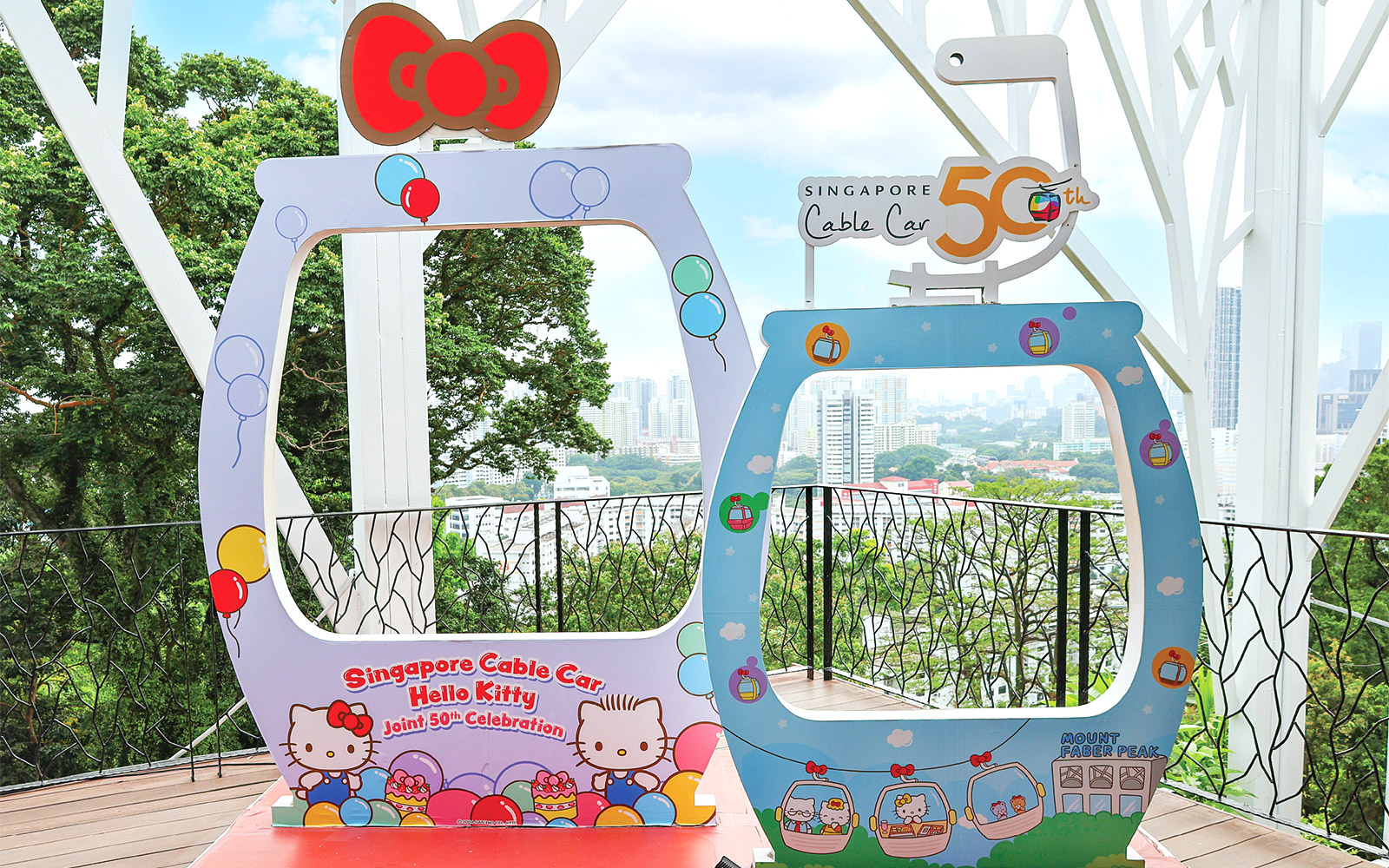 Singapore Cable Car Hello Kitty 50th celebration frame with city skyline in background.