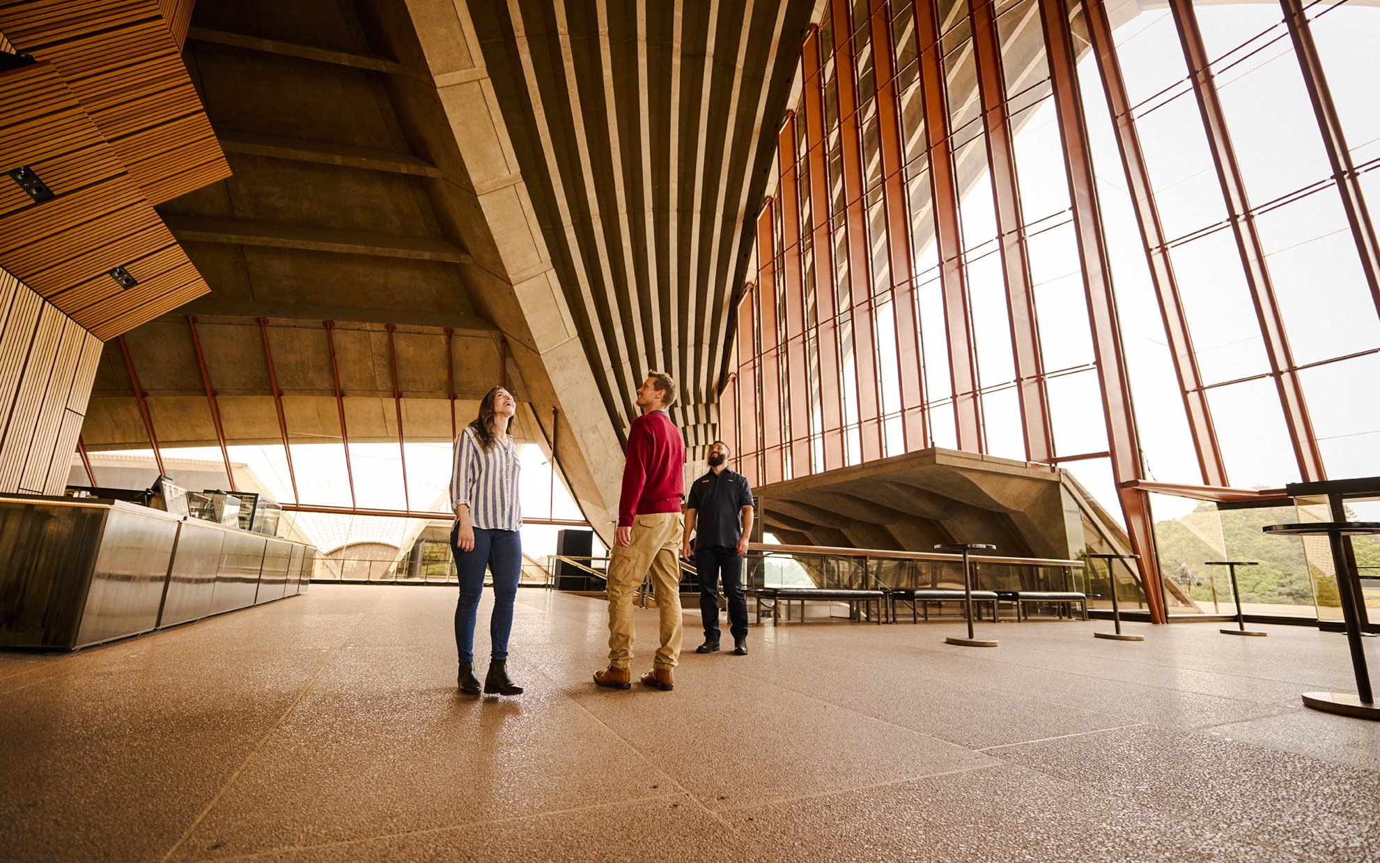 Visitors on a guided tour inside the Sydney Opera House, admiring the unique architecture.