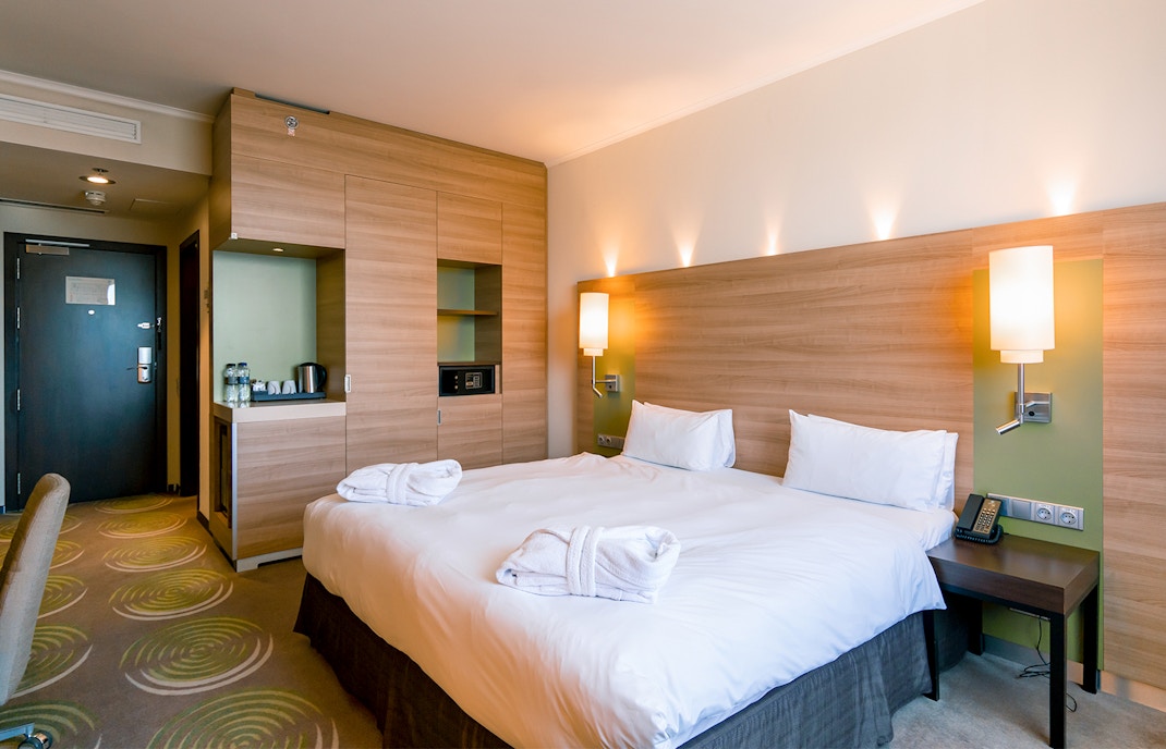 Luxury hotel bedroom interior after housekeeping cleaning.