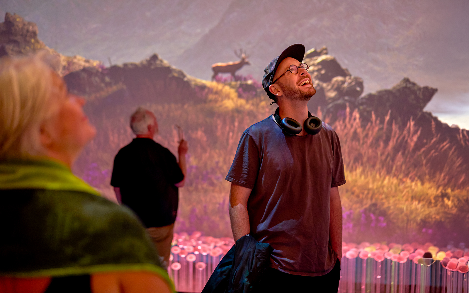 Visitors enjoying a sensory video journey through Scotland with scenic landscapes.