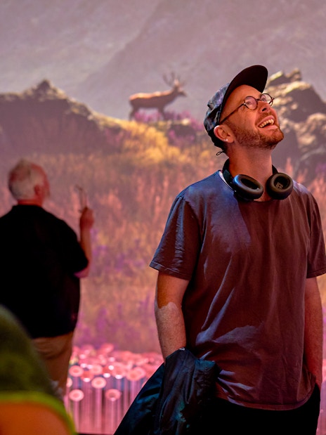 Visitors enjoying a sensory video journey through Scotland with scenic landscapes.