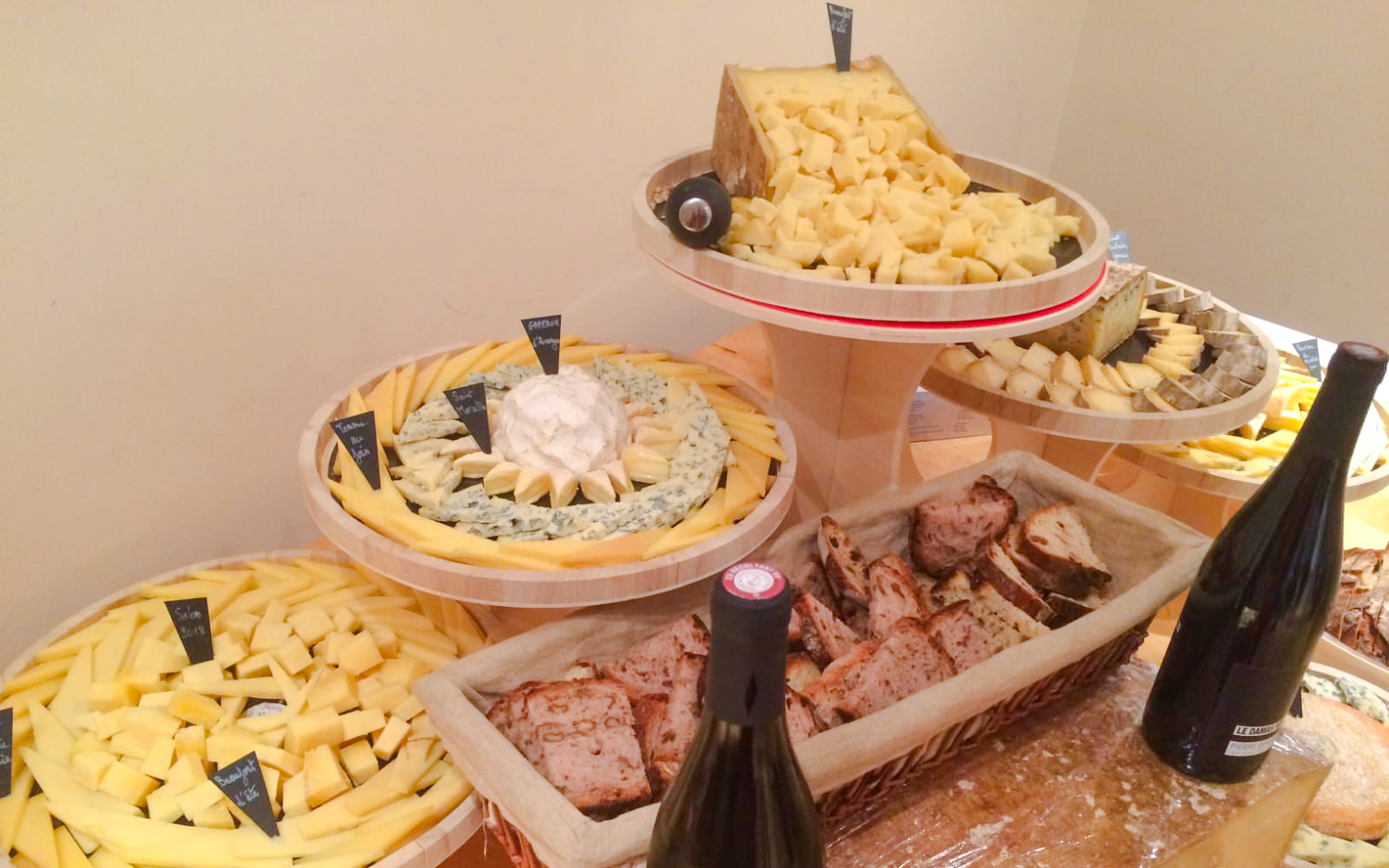 Cheese selection with labels and bread at the Cheese Museum, Paris, France.