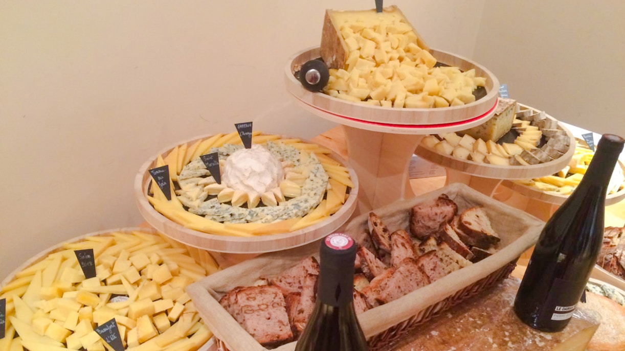 Cheese selection with labels and bread at the Cheese Museum, Paris, France.