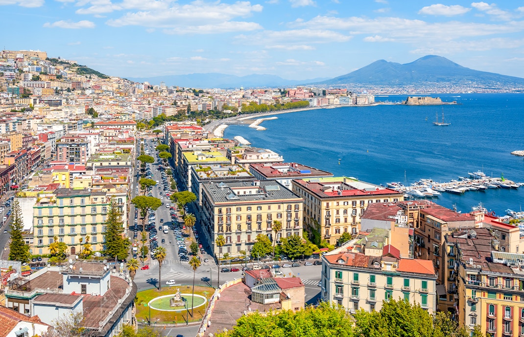 Panoramic view of Naples cityscape with Mount Vesuvius in the background, Italy.