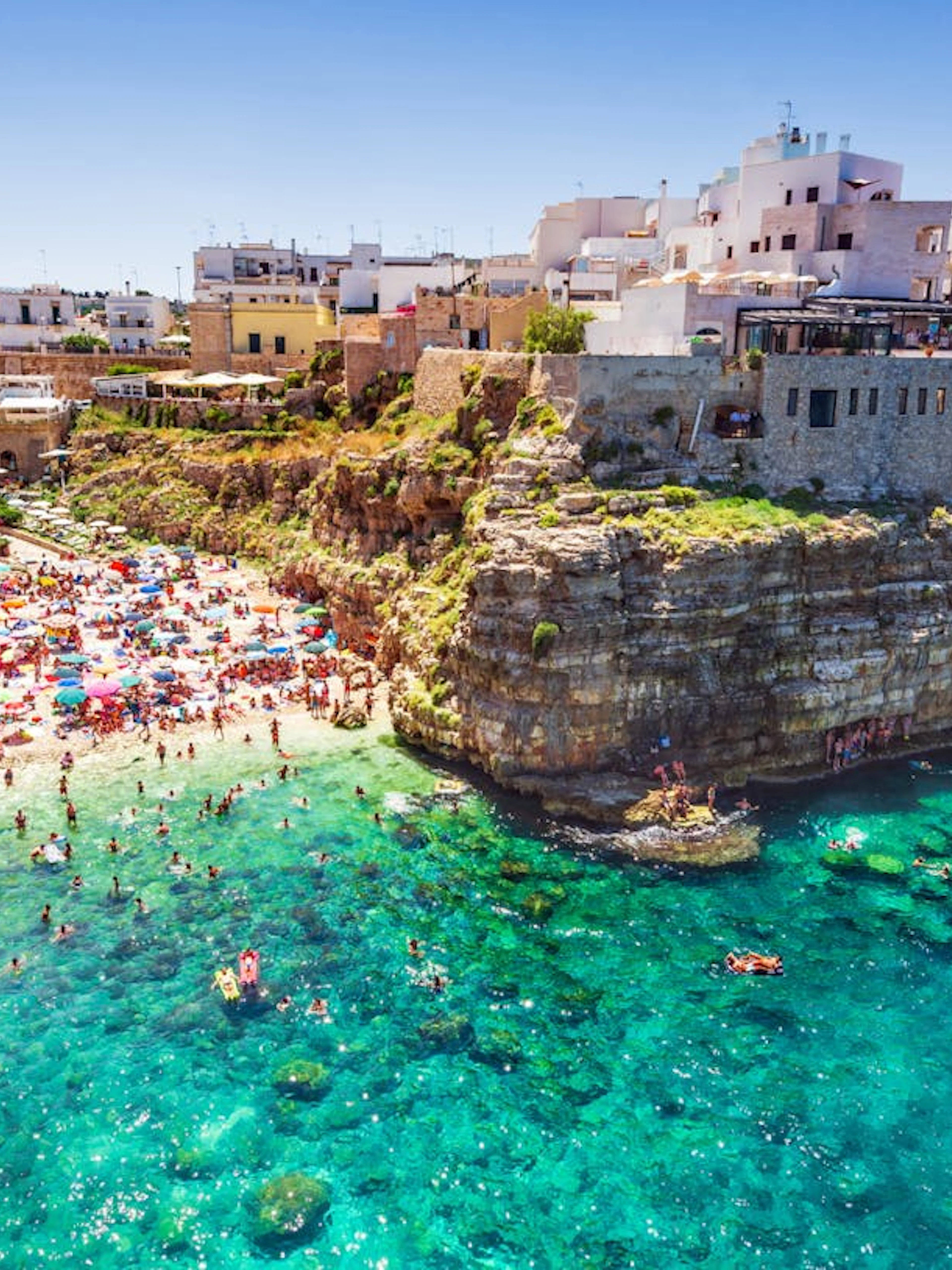 Polignano a Mare beach with cliffs and turquoise water, Valle d'Itria tour.