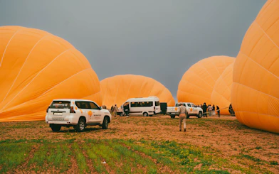 Hot air balloons being prepared for flight in Marrakech field.