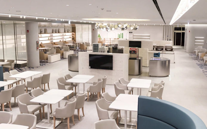 Matina Lounge seating area at Incheon International Airport Terminal 2, featuring modern decor and dining tables.