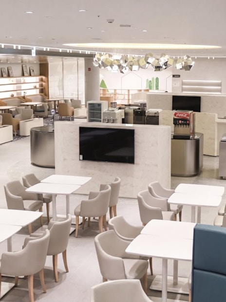 Matina Lounge seating area at Incheon International Airport Terminal 2, featuring modern decor and dining tables.