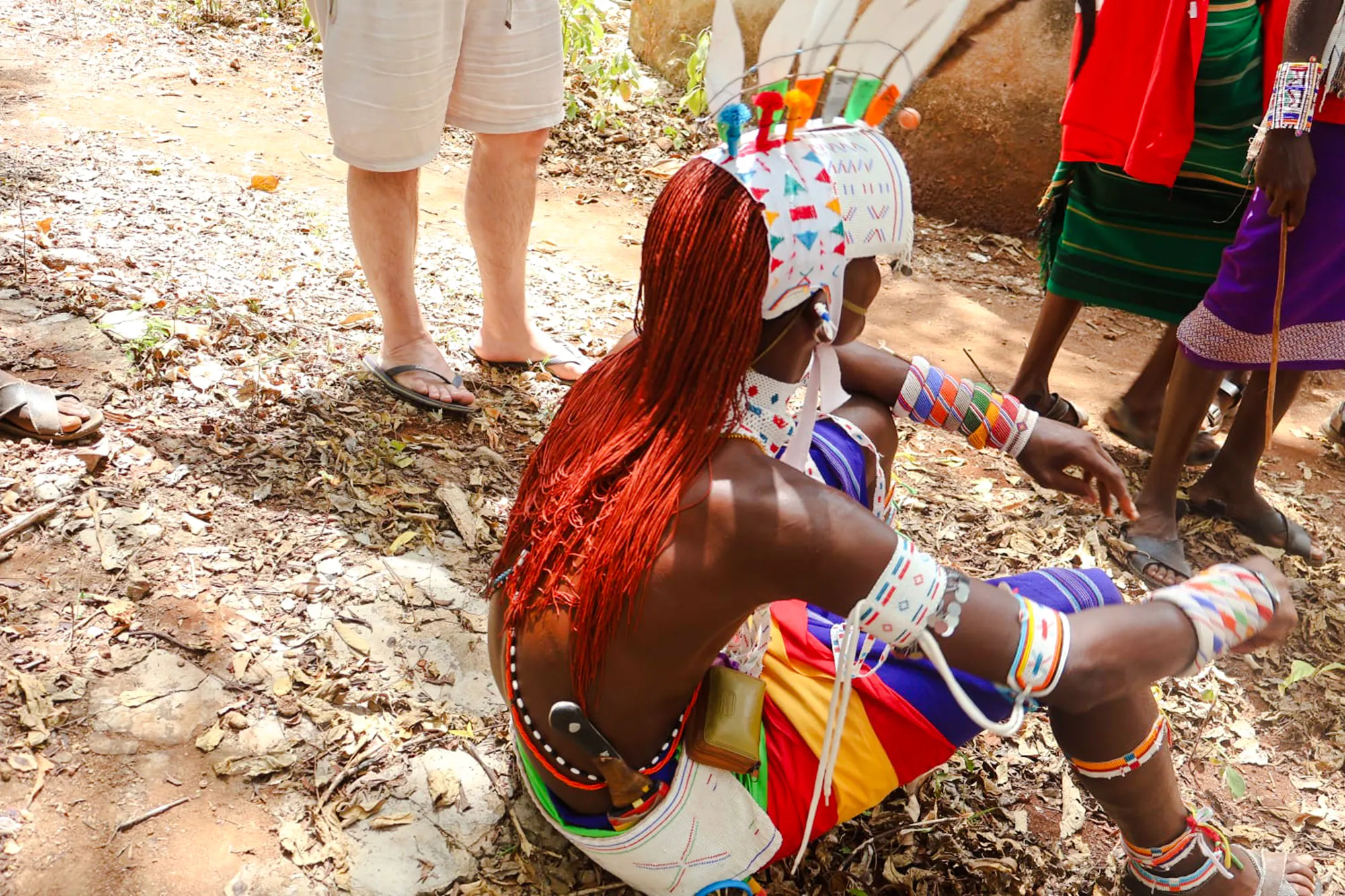Maasai performer in traditional attire during cultural activity at Diani Beach.