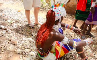 Maasai performer in traditional attire during cultural activity at Diani Beach.