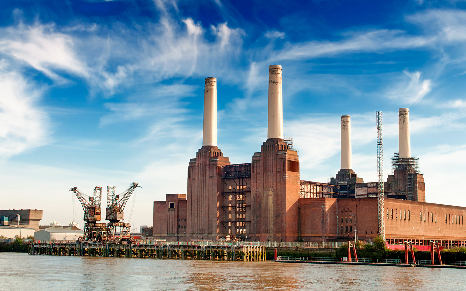 Battersea Power Station with four chimneys by the River Thames, London.