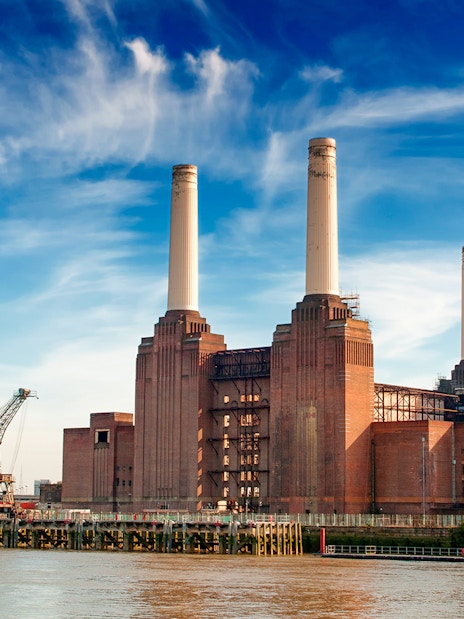 Battersea Power Station with four chimneys by the River Thames, London.