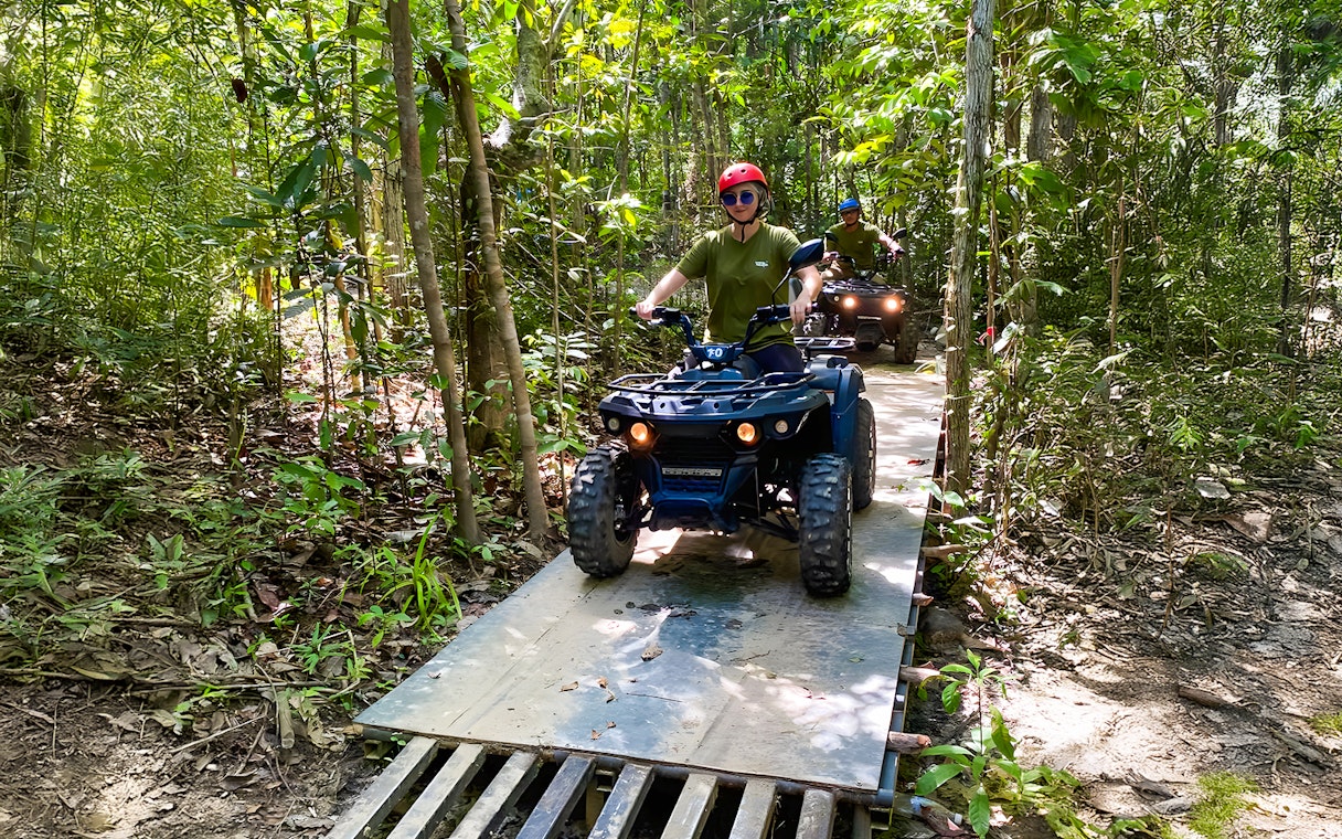 ATV riders navigating forest trail on Langkawi Sky ATV Ride, Mountain Manchinchang.