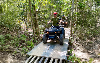 ATV riders navigating forest trail on Langkawi Sky ATV Ride, Mountain Manchinchang.