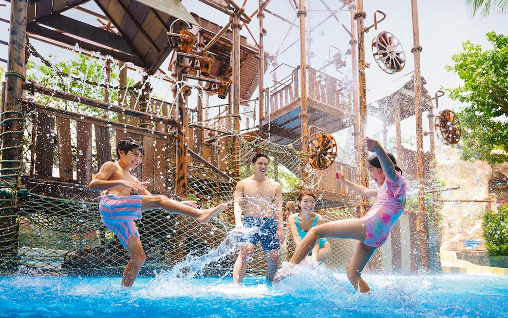 Visitors enjoying water play at Adventure Cove Waterpark™ with interactive structures.