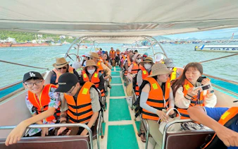 Tourists on a boat wearing life jackets during Nha Trang island-hopping adventure.