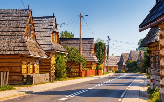 Traditional wooden houses in Zakopane, Poland, along a quiet street.