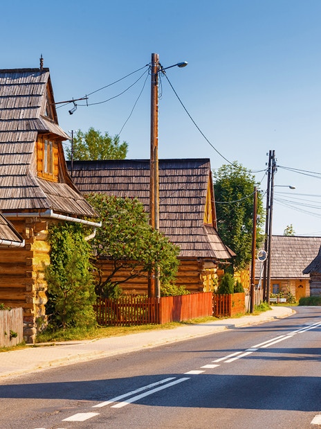 Traditional wooden houses in Zakopane, Poland, along a quiet street.