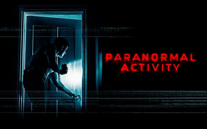 Man with flashlight opening door, Paranormal Activity Westend show.