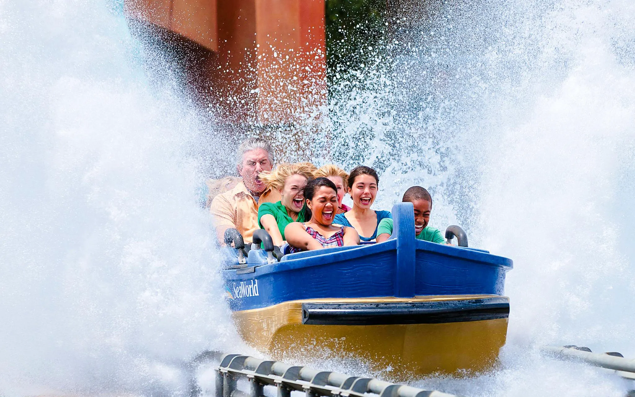 Visitors enjoying a water ride splash at SeaWorld San Diego.