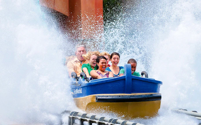 Visitors enjoying a water ride splash at SeaWorld San Diego.