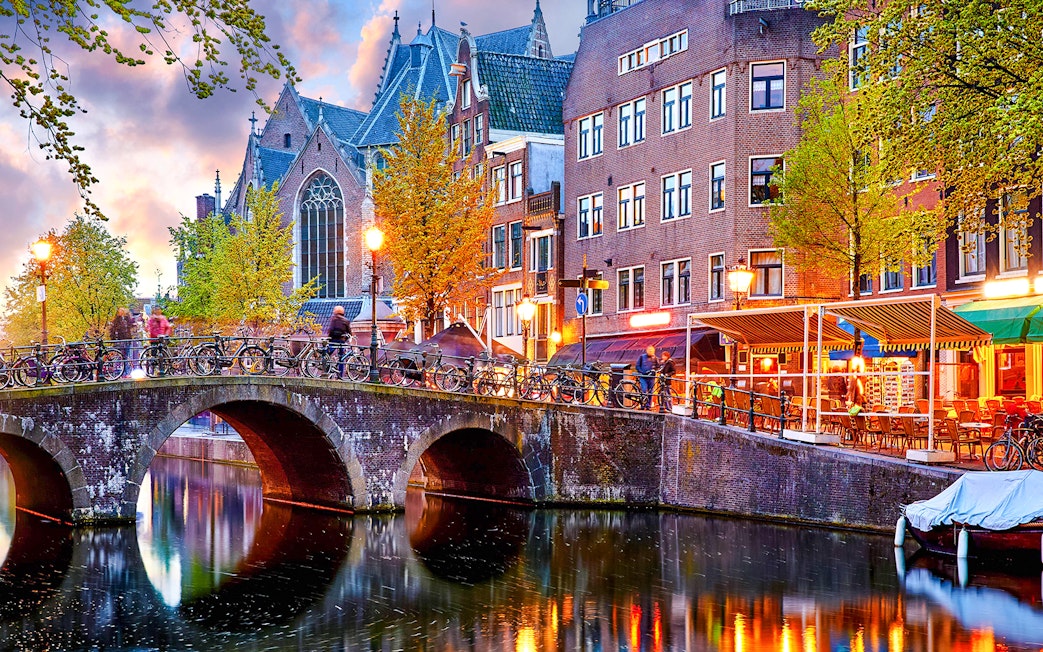 Canal bridge and historic buildings in Amsterdam Red Light District.